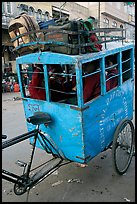 Schoolchildren in an enclosed  box towed by cycle. New Delhi, India ( color)