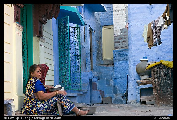 Women sitting in alley painted with indigo tinge. Jodhpur, Rajasthan, India (color)