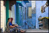 Women sitting in alley painted with indigo tinge. Jodhpur, Rajasthan, India ( color)