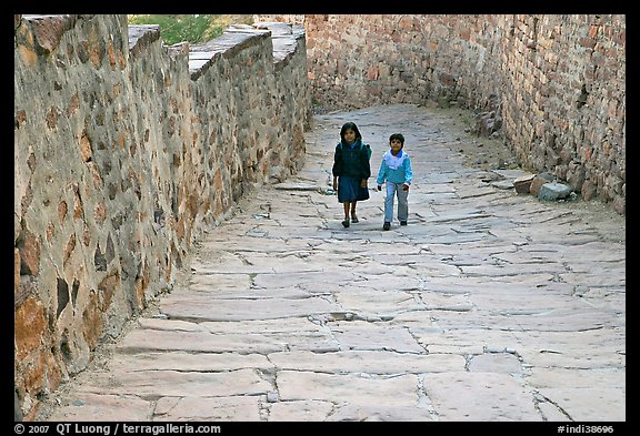 Children walking on the stone ramp leading to the fort. Jodhpur, Rajasthan, India (color)