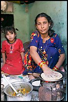 Woman and girl preparing chapati bread. Jodhpur, Rajasthan, India ( color)