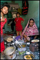 Woman cooking, flanked by two girls. Jodhpur, Rajasthan, India ( color)