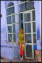 Woman stepping out of door. Jodhpur, Rajasthan, India (color)