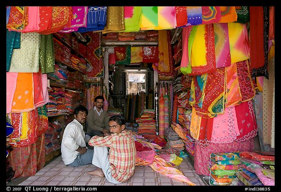 Men in shop selling colorful fabrics, Sardar market. Jodhpur, Rajasthan, India (color)