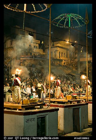 Holy hindu men facing audience during evening arti ceremony. Varanasi, Uttar Pradesh, India