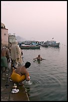 Hindu men dipping in the Ganges River at dawn. Varanasi, Uttar Pradesh, India