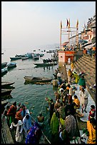 Boat unloading pilgrim onto Dasaswamedh Ghat, early morning. Varanasi, Uttar Pradesh, India (color)