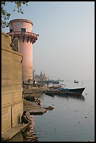 Man sitting on edge of Ganges River. Varanasi, Uttar Pradesh, India ( color)