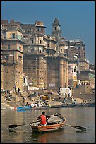 Man rowing boat beneath Munshi Ghat. Varanasi, Uttar Pradesh, India (color)