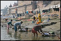 Men washing laundry on Ganga riverbanks. Varanasi, Uttar Pradesh, India