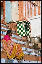 Woman sitting on temple steps. Varanasi, Uttar Pradesh, India (color)