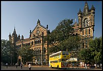 Yellow double-decker bus in front of Victoria Terminus. Mumbai, Maharashtra, India (color)