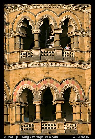 Facade with woman at window, Chhatrapati Shivaji Terminus. Mumbai, Maharashtra, India (color)