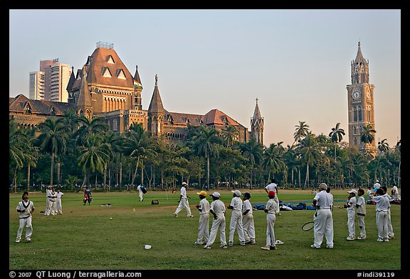 Boys in cricket attire on Oval Maidan, High Court, and Rajabai Tower. Mumbai, Maharashtra, India