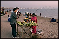 Food stall selling braised corn at twilight,  Chowpatty Beach. Mumbai, Maharashtra, India