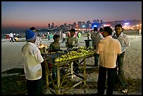 Stall broiling corn at night, Chowpatty Beach. Mumbai, Maharashtra, India