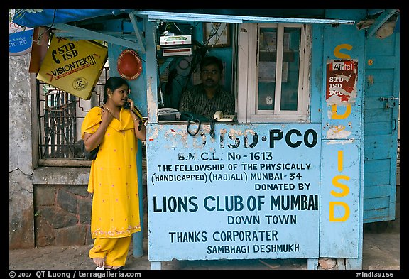 Woman at a street telephone booth. Mumbai, Maharashtra, India (color)
