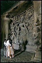 Family looking at Ardhanarishwar Siva sculpture, main Elephanta cave. Mumbai, Maharashtra, India (color)