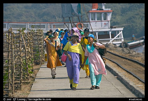 Women walking on  jetty, Elephanta Island. Mumbai, Maharashtra, India