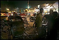 Cycle-rickshaws and vending booths at night, Agra cantonment. Agra, Uttar Pradesh, India ( color)