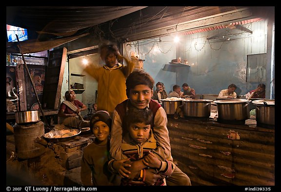 Children and food booth at night, Agra cantonment. Agra, Uttar Pradesh, India (color)