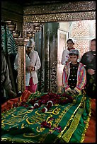 Family making offering on Shaikh Salim Chishti tomb. Fatehpur Sikri, Uttar Pradesh, India (color)