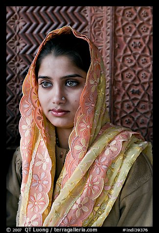 Young woman with embroided scarf, in front of Rumi Sultana wall. Fatehpur Sikri, Uttar Pradesh, India