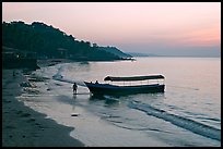 Narrow boat on beach at dawn, Dona Paula. Goa, India (color)