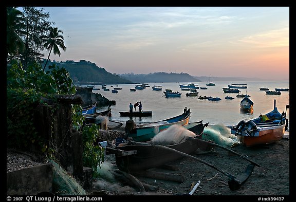 Fishing boats on beach, sunrise. Goa, India