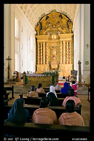 Indian women sitting in front of the altar, Basilica of Bom Jesus, Old Goa. Goa, India (color)