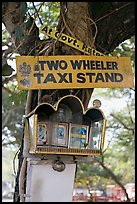 Two wheeler taxi stand and altar on tree. Goa, India (color)