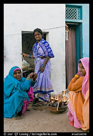 Women cooking outside in village. Khajuraho, Madhya Pradesh, India