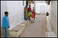 Family in village alley. Khajuraho, Madhya Pradesh, India (color)