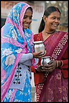 Women with pots used for religious offerings. Khajuraho, Madhya Pradesh, India