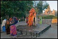 Women throwing water at  Shiva image. Khajuraho, Madhya Pradesh, India (color)