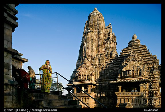 Woman with offering pot in front of Lakshmana temple. Khajuraho, Madhya Pradesh, India (color)