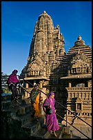 Women going down stairs in front of Lakshmana temple. Khajuraho, Madhya Pradesh, India (color)