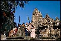 Worshippers making offering at Matangesvara temple with  Lakshmana behind. Khajuraho, Madhya Pradesh, India