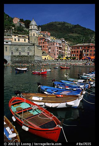 Colorful samll fishing boats in the harbor and main plaza, Vernazza. Cinque Terre, Liguria, Italy