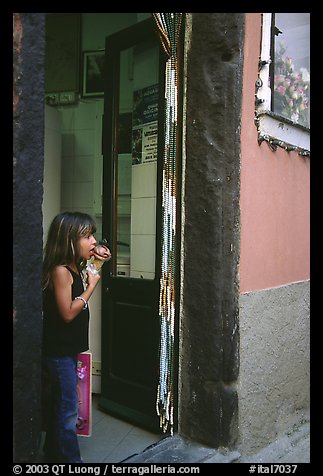 Girl enjoying gelato (ice-cream), Vernazza. Cinque Terre, Liguria, Italy (color)