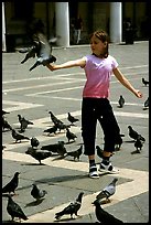 Girl playing with the pigeons, Piazzetta San Marco (Square Saint Mark), mid-day. Venice, Veneto, Italy