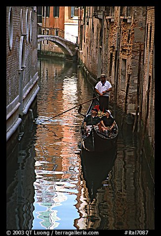 Gondola and reflections in a narrow canal. Venice, Veneto, Italy