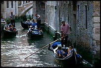 Several gondolas in a narrow canal. Venice, Veneto, Italy