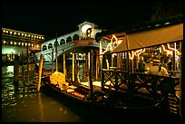 Gondolier and gondola, Rialto Bridge at night. Venice, Veneto, Italy