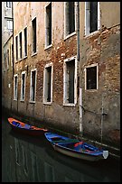 Small boats moored along a wall in a small side canal. Venice, Veneto, Italy ( color)