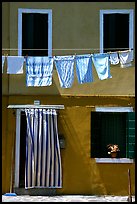 Hanging laundry and colored wall, Burano. Venice, Veneto, Italy (color)