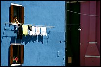 Woman hangs laundry to dry, Burano. Venice, Veneto, Italy ( color)