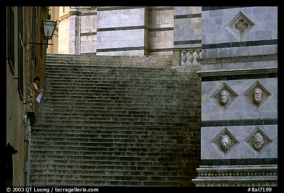 Woman cleaning up besides the Duomo stairs. Siena, Tuscany, Italy (color)