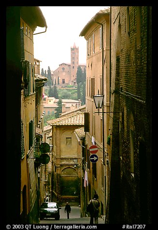 Narrow street with church in background. Siena, Tuscany, Italy