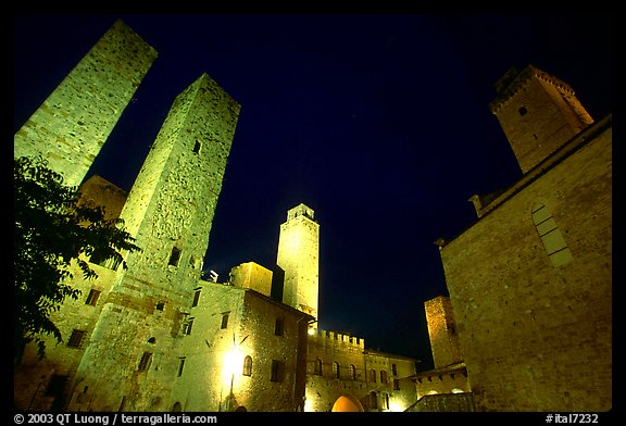 Medieval towers above Piazza del Duomo at night. San Gimignano, Tuscany, Italy